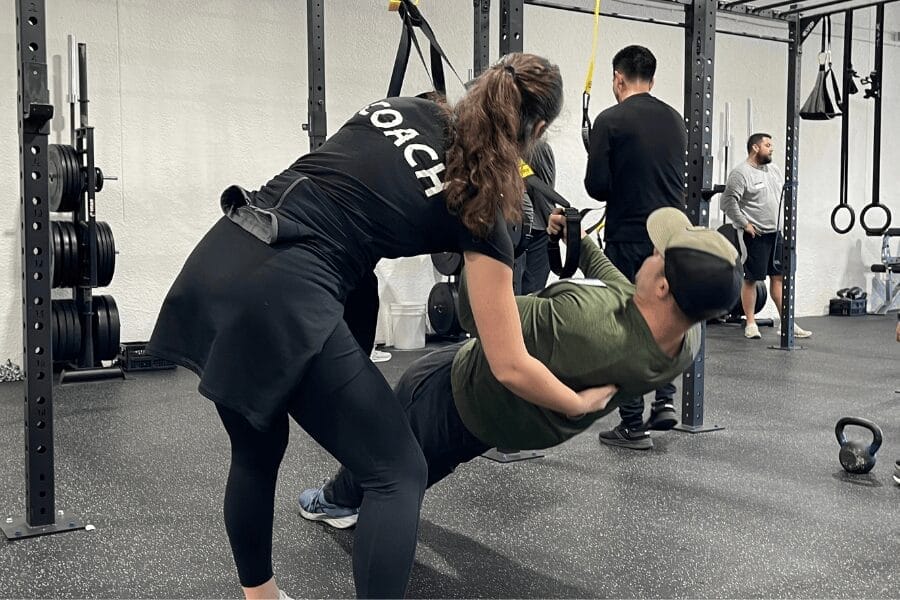 Personal trainer working with client at Evexia in Overland Park, KS—building strength, consistency, and confidence